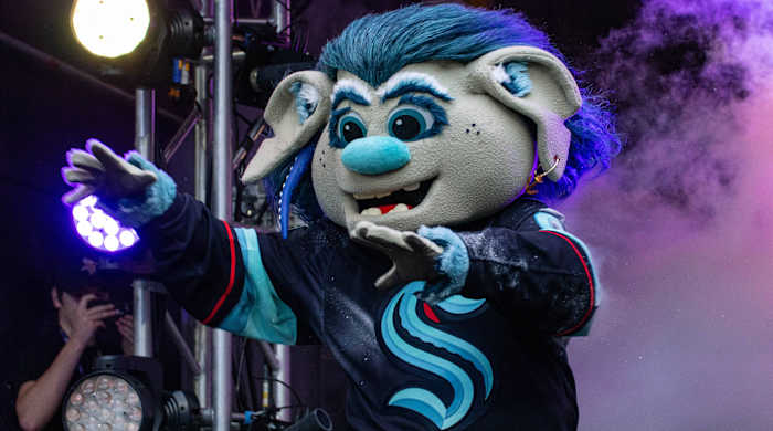 Seattle Kraken mascot Buoy exits the tunnel onto the field during an NFL game between the Indianapolis Colts and Minnesota Vikings.